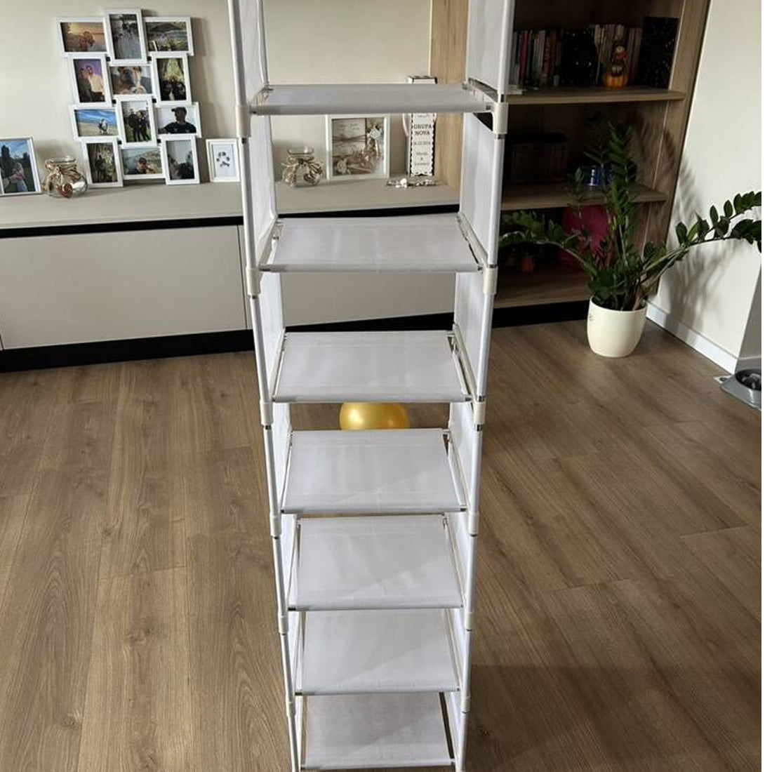 Empty white metal shoe rack on a wooden floor