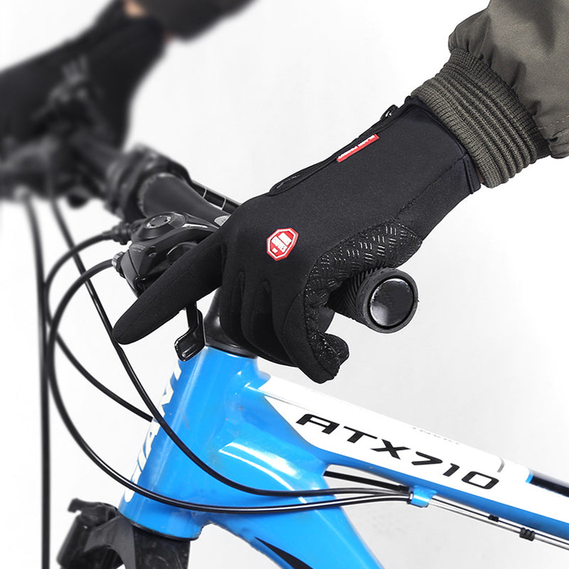 Black winter gloves gripping a bicycle handlebar