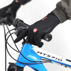 Black winter gloves gripping a bicycle handlebar